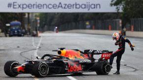 Max Verstappen kicks his Pirelli tires in frustration after crashing out due to a tire failure