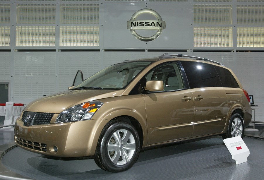 a gold nissan quest minivan at an auto show