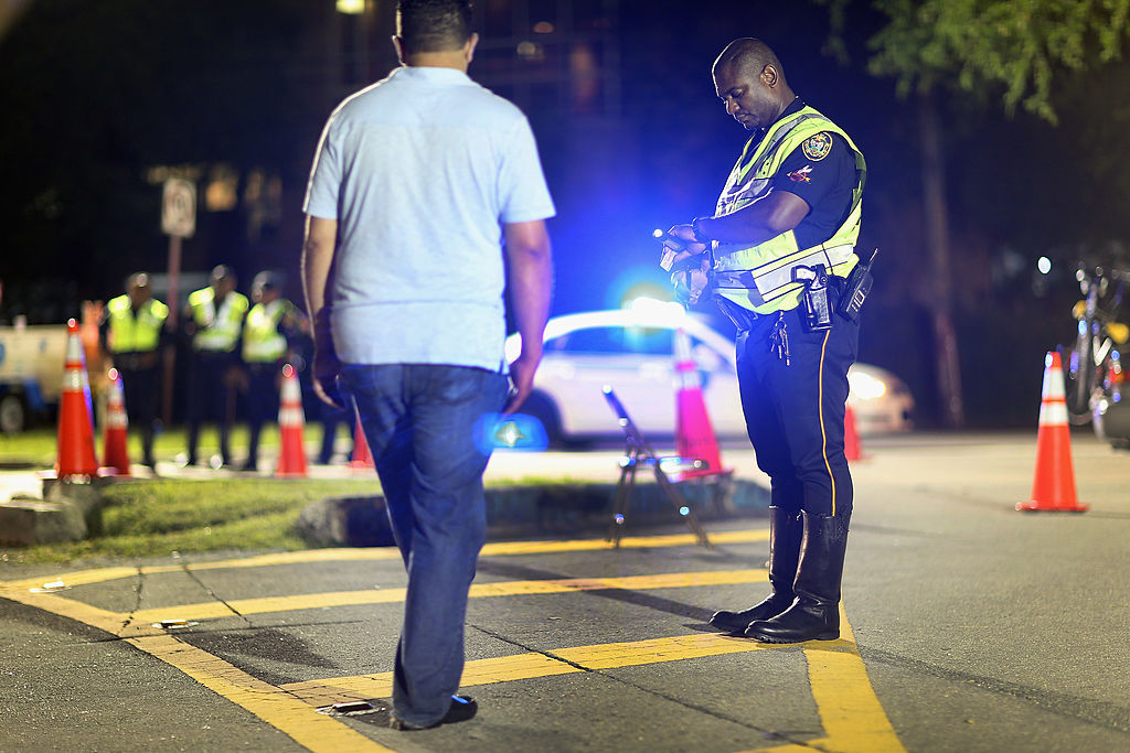 a cop at a DUI checkpoint performing tests 