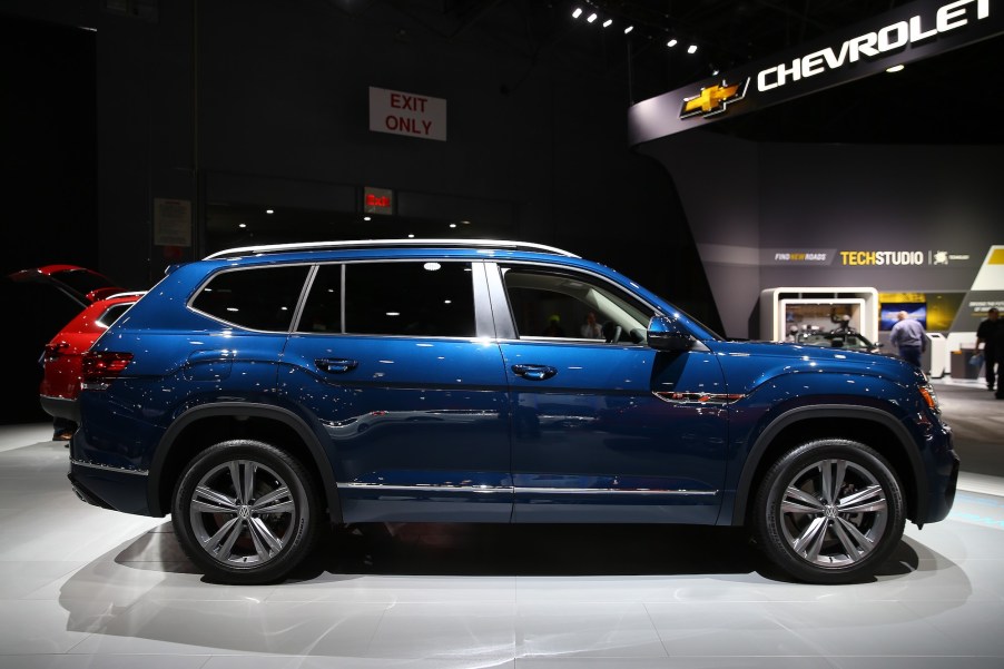 A dark blue Volkswagen Atlas on display at a car show side view photo