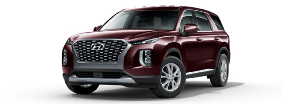 A maroon 2021 Hyundai Palisade against a white background.