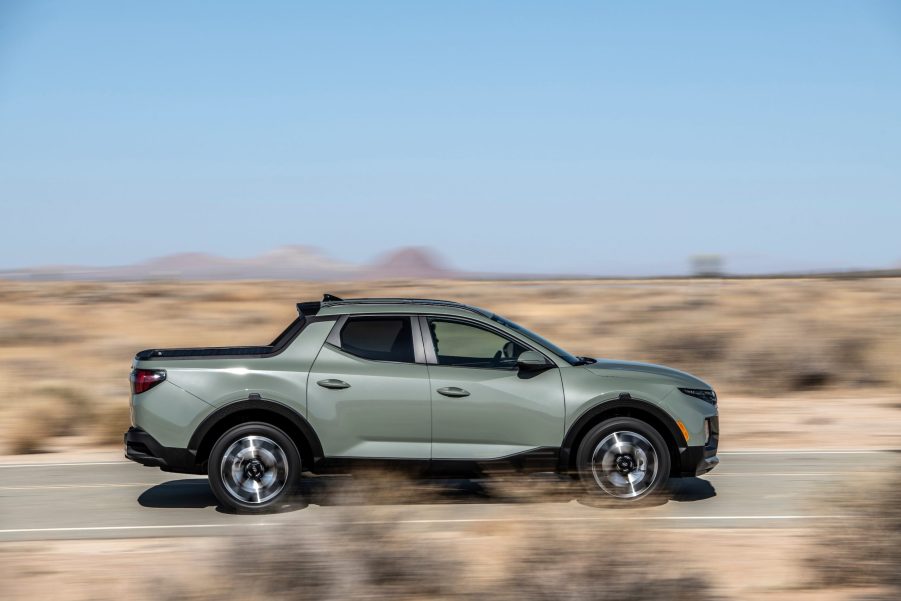 The 2022 Hyundai Santa Cruz in a gray color driving along the road in the desert