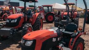 Various Kubota tractor models on display at a dealership.