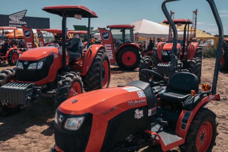 Various Kubota tractor models on display at a dealership.