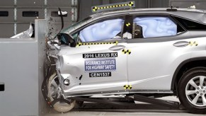 A silver Lexus RX is being crash tested.