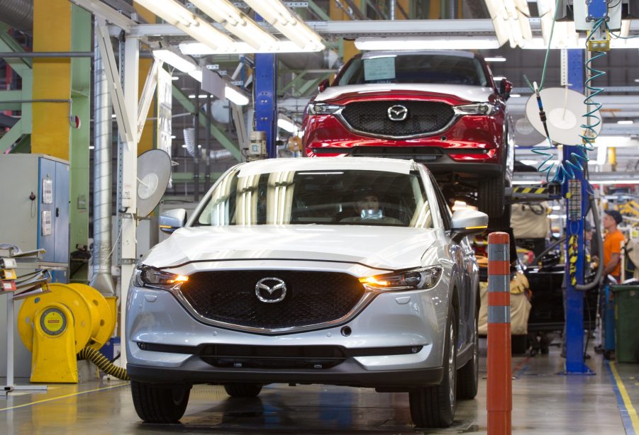 A worker drives a Mazda Motor Corp. CX-5 sports utility vehicle (SUV) on the assembly line at the Mazda Sollers Manufacturing Rus LLC plant