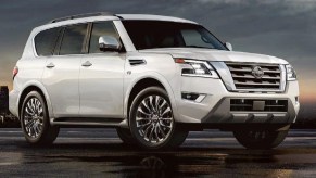 A white 2021 Nissan Armada parked in front of a setting sun.