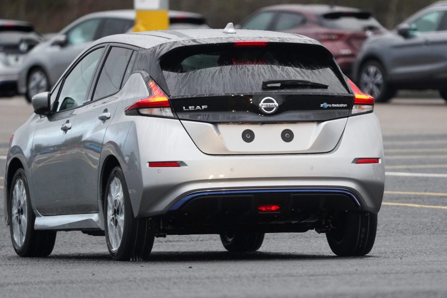 A newly manufactured gray Nissan Leaf electric vehicle is driven from the production line to be parked at the Nissan Motor Co. plant