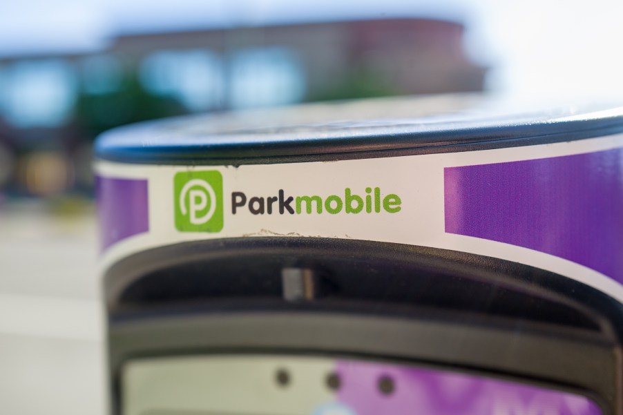 A white and purple parking meter with a black and green ParkMobile logo in downtown Walnut Creek, California, in April 2019