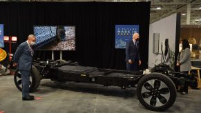 President Joe Biden examines the battery pack and chassis of a Ford EV