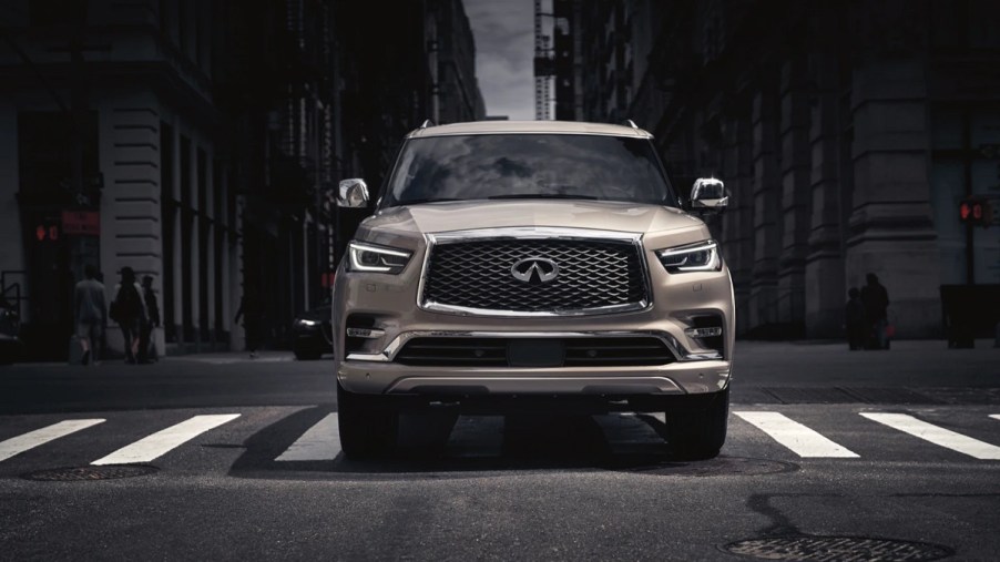 A gold 2021 Infiniti QX80 at a crosswalk.