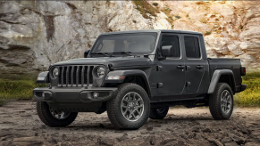 A grey 2021 Jeep Gladiator parked on rocky terrain