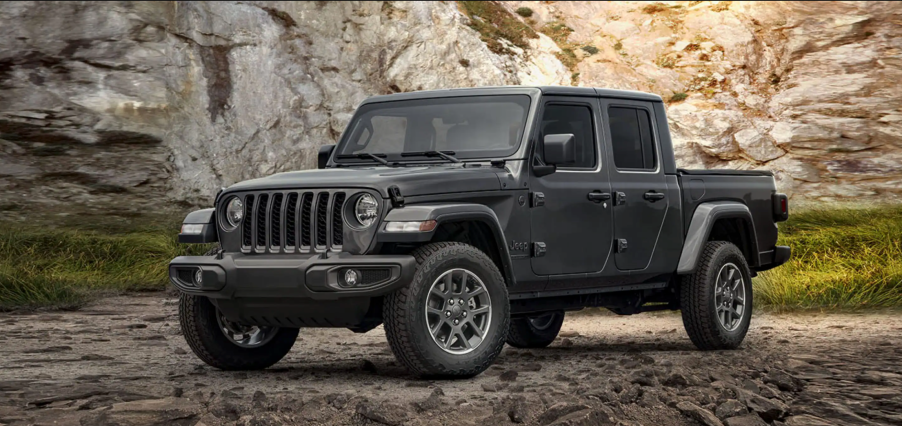 A grey 2021 Jeep Gladiator parked on rocky terrain