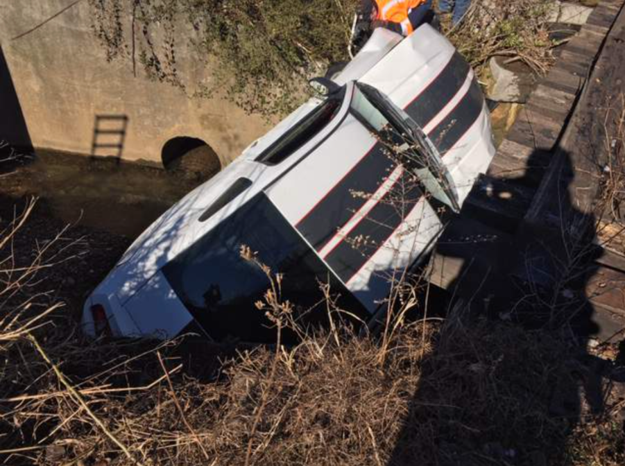 An image of a crashed Ford Mustang outdoors.