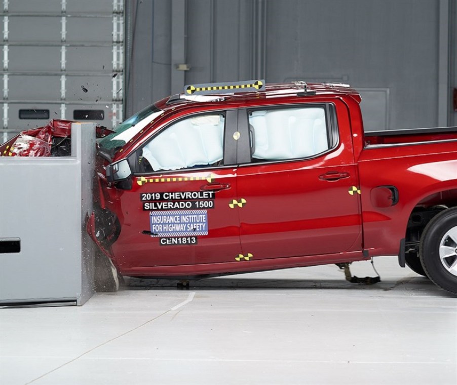 A red Chevy Silverado 1500 is smashed into a wall.