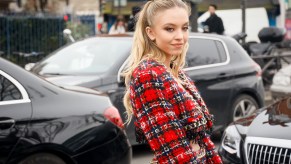 Sydney Sweeney wears a red Balmain tweed jacket and skirt in February 2020 in Paris, France