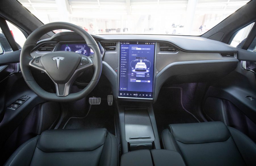 View into the interior with steering wheel and display of a Tesla Model X in the new Tesla Service Center