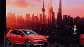 Guo Yongfeng, President of Faw-Volkswagen Sales, presents the new red Volkswagen Golf GTI car during the 19th Shanghai International Automobile Industry Exhibition