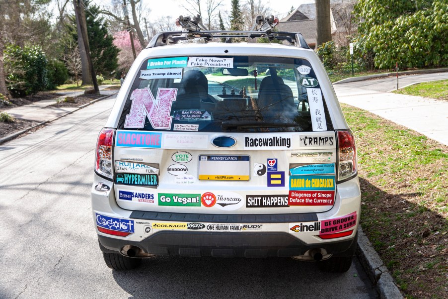 Rear view of a white car with many bumper stickers in Swarthmore, Pennsylvania