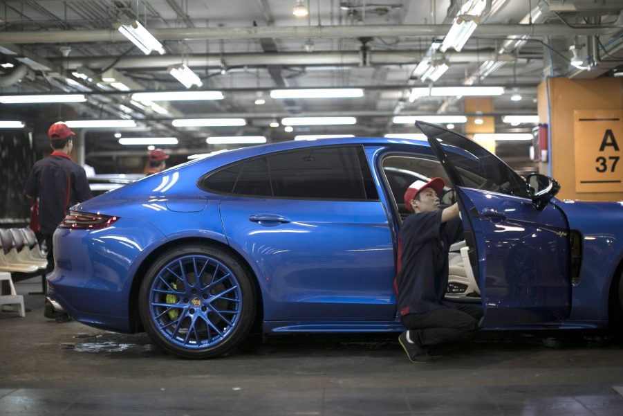 A worker polishes a Porsche AG Panamera