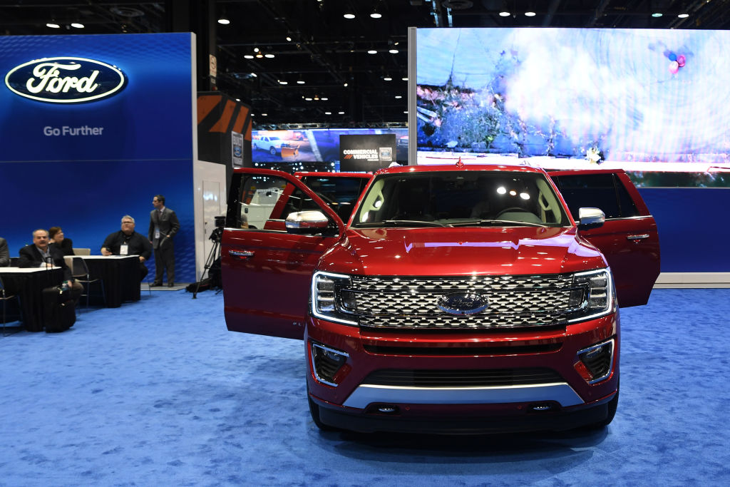 A red Ford Expedition with all of its doors open