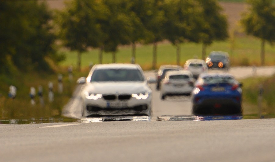 Heat shimmer can be seen on a road busy with cars