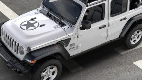 A white Jeep Wrangler with a black star on the hood