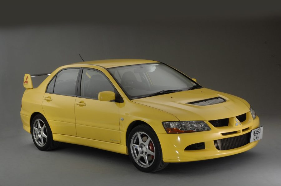 A yellow Mitsubishi Evolution sport sedan