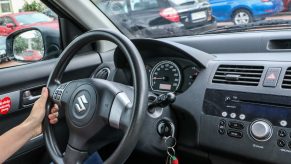 Woman driving her silver Suzuki Swift