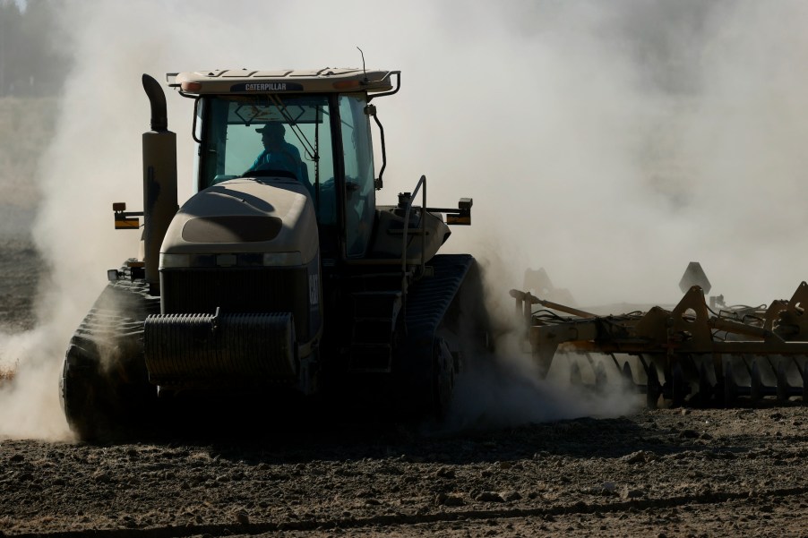 A tractor kicks up dust as it plows a dry field on May 26, 2021, in Chowchilla, California