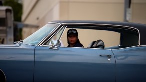 A woman drives a blue car in Van Nuys, California, on May 15, 2021