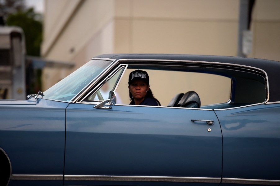 A woman drives a blue car in Van Nuys, California, on May 15, 2021