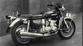 A black-and-white photo of a 1974 Suzuki GT750 in the city