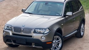 A tan 2008 BMW X3 3.0si parked by the side of the road