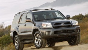 A grey 2009 Toyota 4Runner on the trails, the 2009 Toyota 4Runner is one of the best used three-row SUVs under $15,000