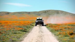 2017 Toyota Tacoma driving down a long dirt road