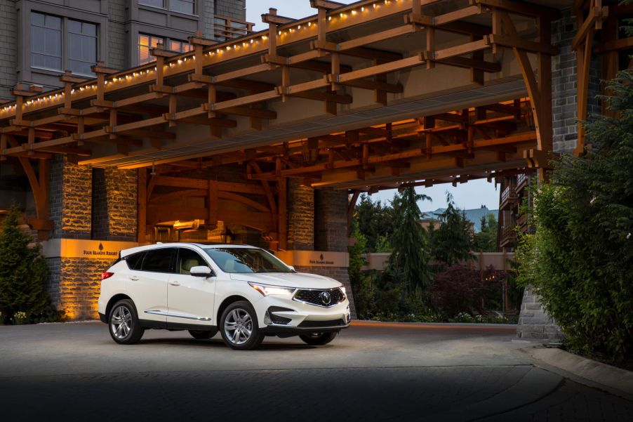 A white 2019 Acura RDX Advance SUV model parked under a bridge