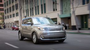 A gray 2019 Kia Soul EV model driving through a city