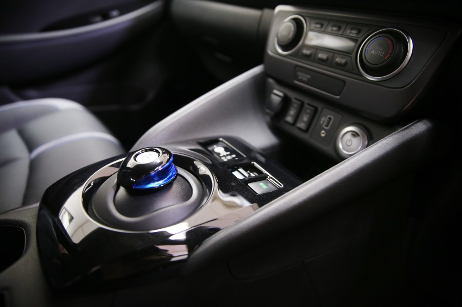 A 2019 Nissan Leaf's center console showing a gear shifter and other controls. The Leaf is vegan-friendly.