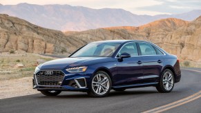 A 2021 Audi A4 parked on the side of the road with mountains and desert behind it, the 2021 Audi A4 is an AWD sedan