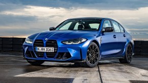 A blue 2021 BMW M3 Competition on a runway