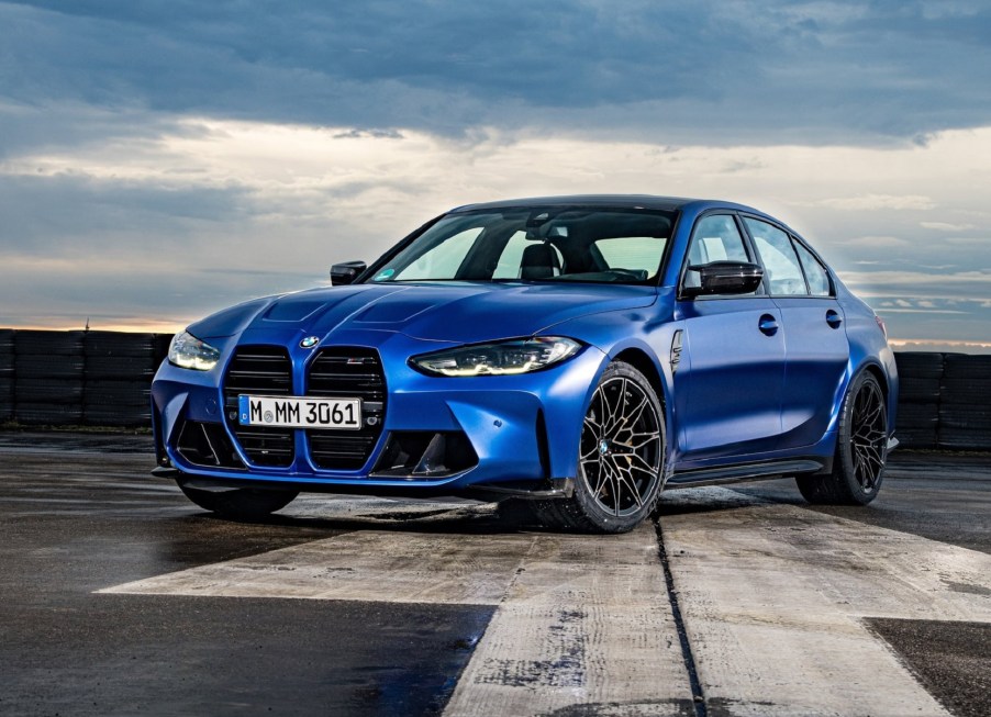 A blue 2021 BMW M3 Competition on a runway