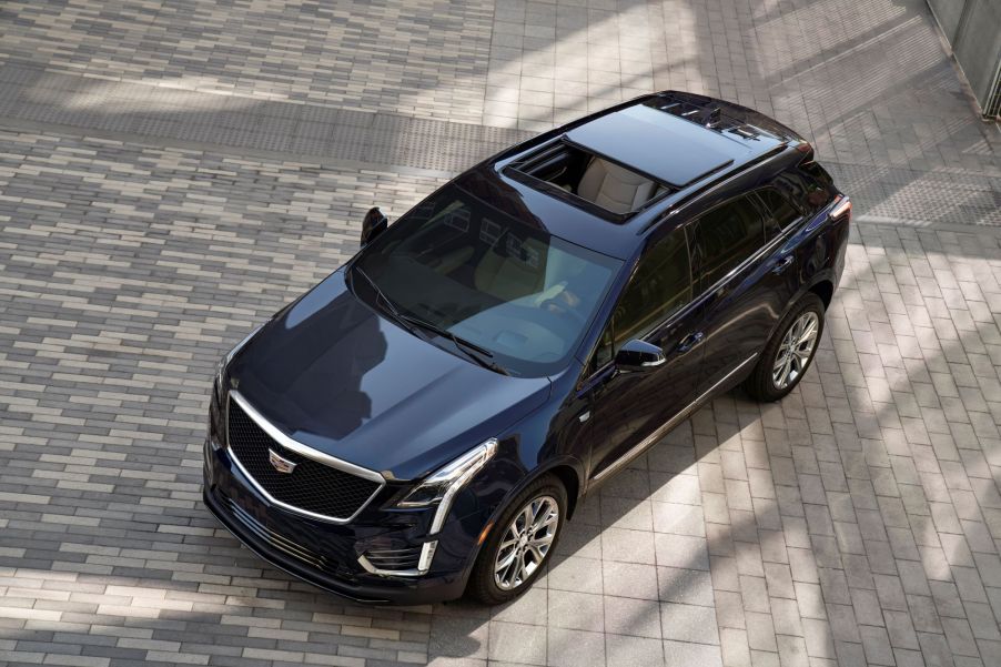 An aerial view of a black 2021 Cadillac XT5 on a grey brick driveway.