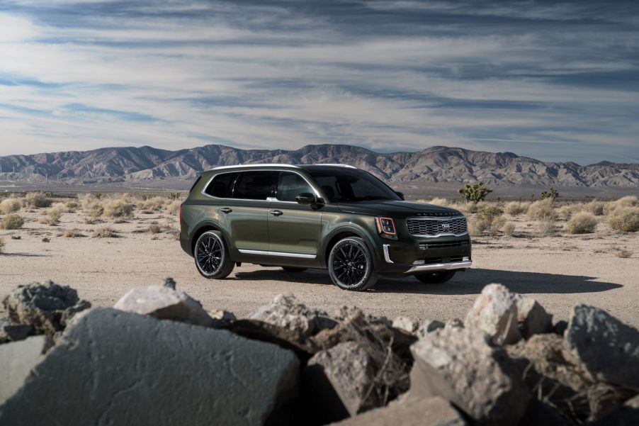 A dark green 2021 Kia Telluride SUV parked in a desert field