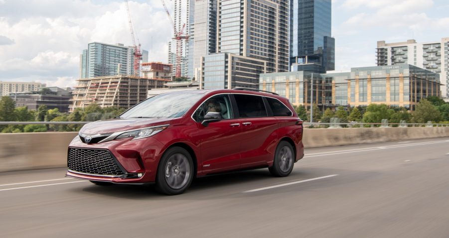 Red 2021 Toyota Sienna Driving Down The Highway