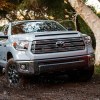 A white 2021 Toyota Tundra driving through the woods.