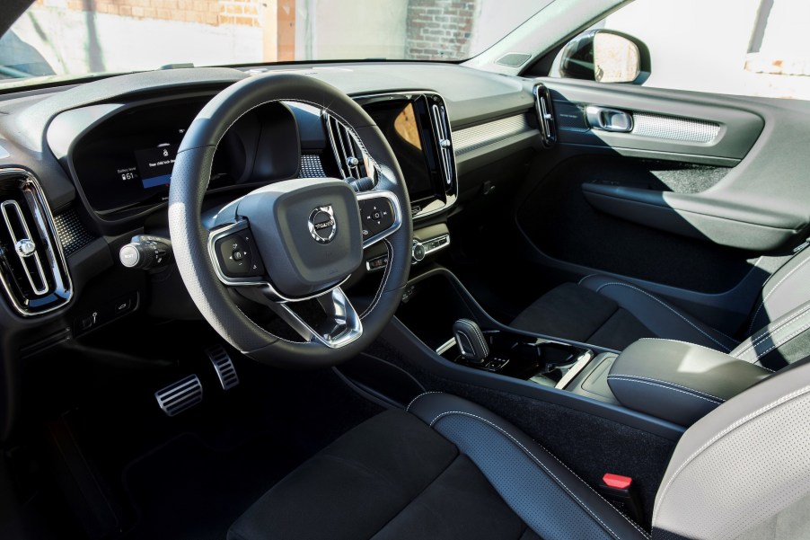 Interior view of the front seats, steering wheel, and dashboard of a 2021 Volvo XC40 Recharge electric compact SUV