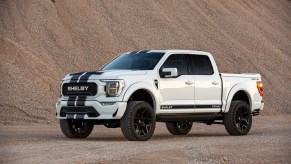 A white 2021 Ford F-150 Shelby parked in the sand