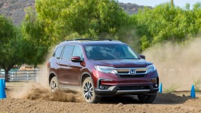 honda pilot driving through dirt