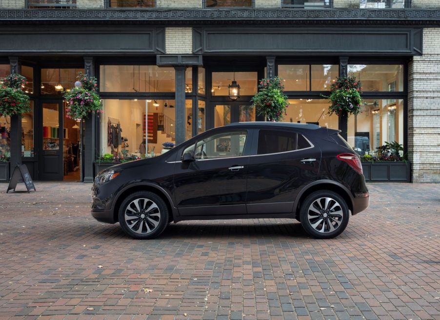 A 2022 Buick Encore compact SUV model parked near a store on a cobblestone road